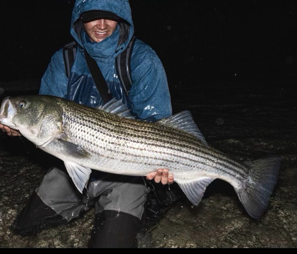 Finn Hawley with a striped bass